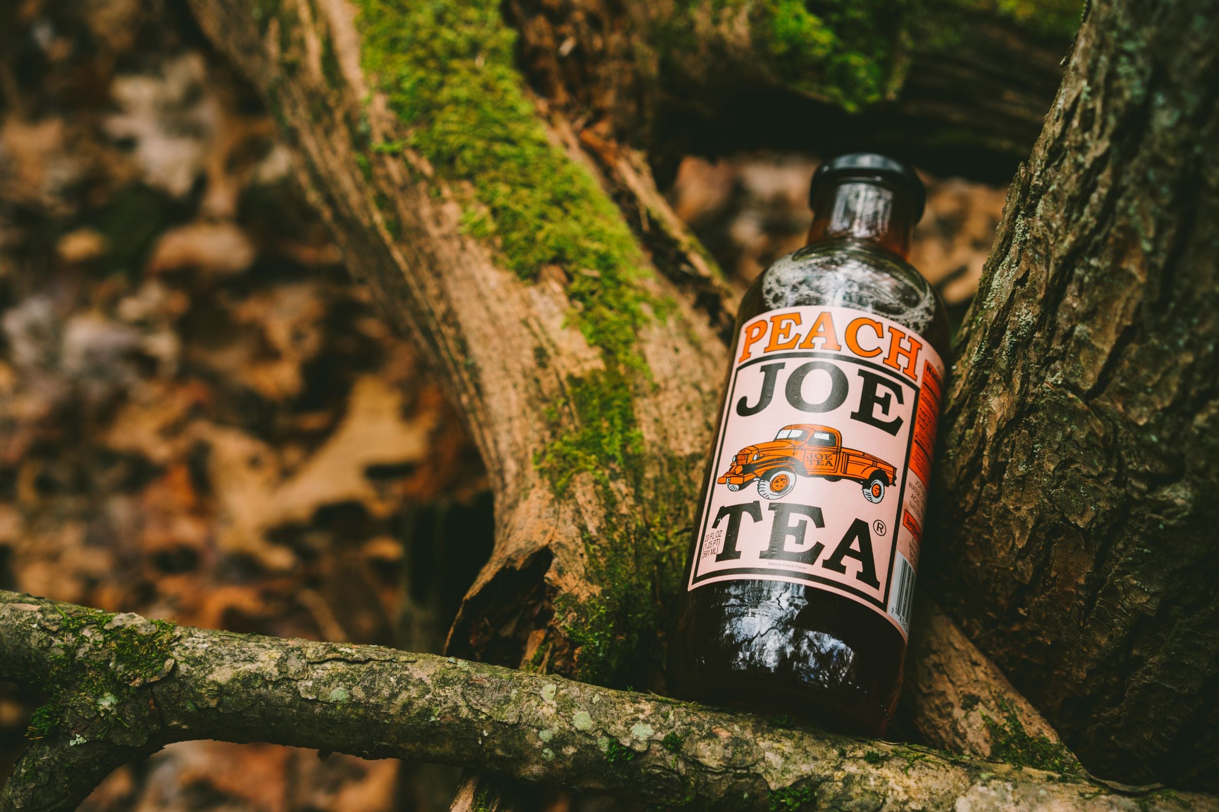 peach tea bottle in nature